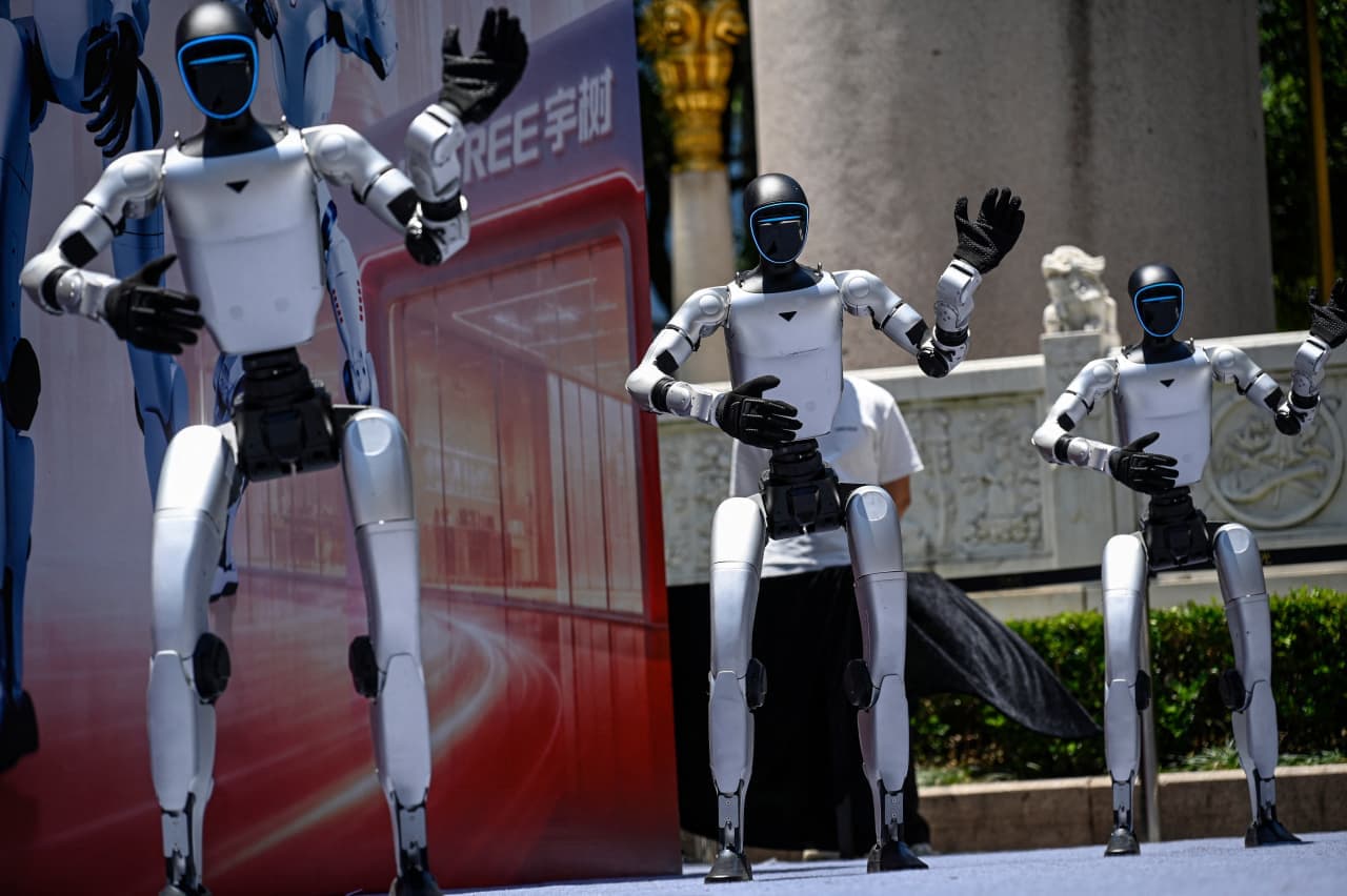 Trump signs an executive order on AI after it’s scaled back. Critics say it’s almost meaningless.