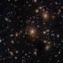 Hubble captures galaxy swarm with lensed arcs from early universe